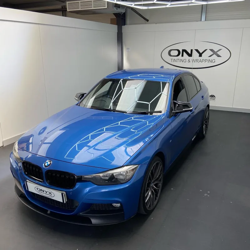 Blue BMW 3 Series F30 with side skirt decals and black M Sport mirrors