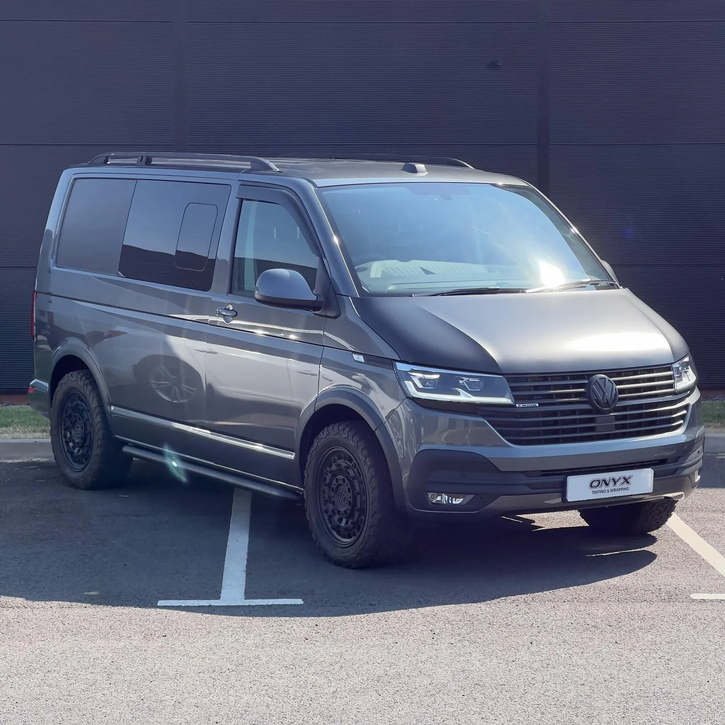 Grey VW Transporter 4Motion with a matte black bonnet and side panels