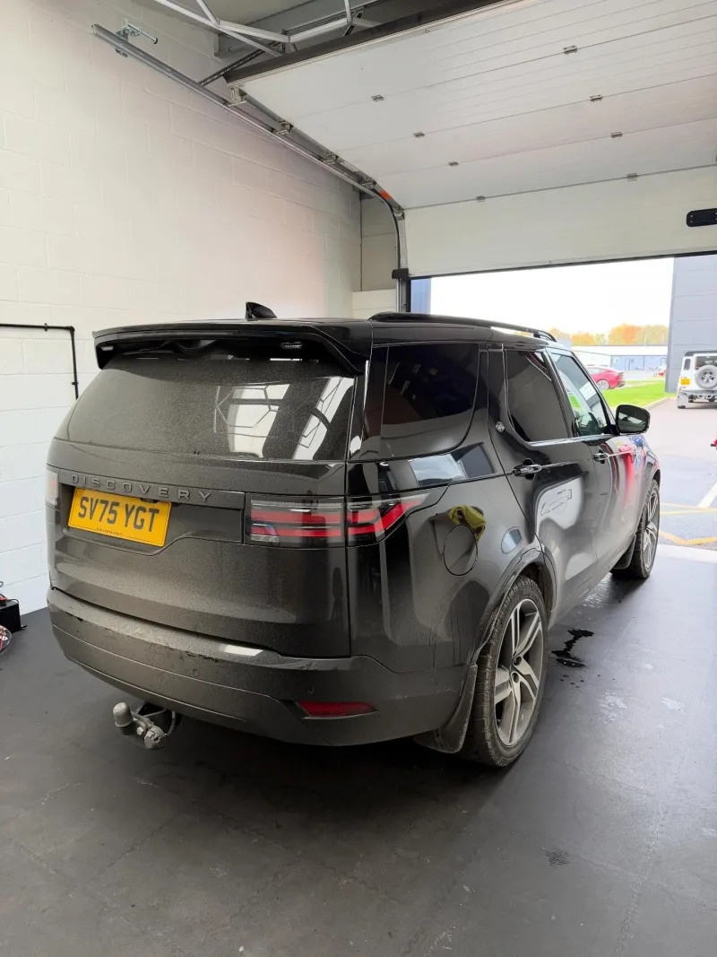 Black Land Rover Discovery with tinted rear side windows
