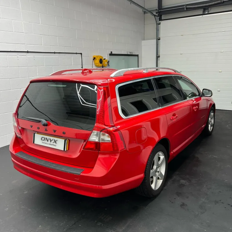 Red Volvo V70 estate with tinted rear side windows
