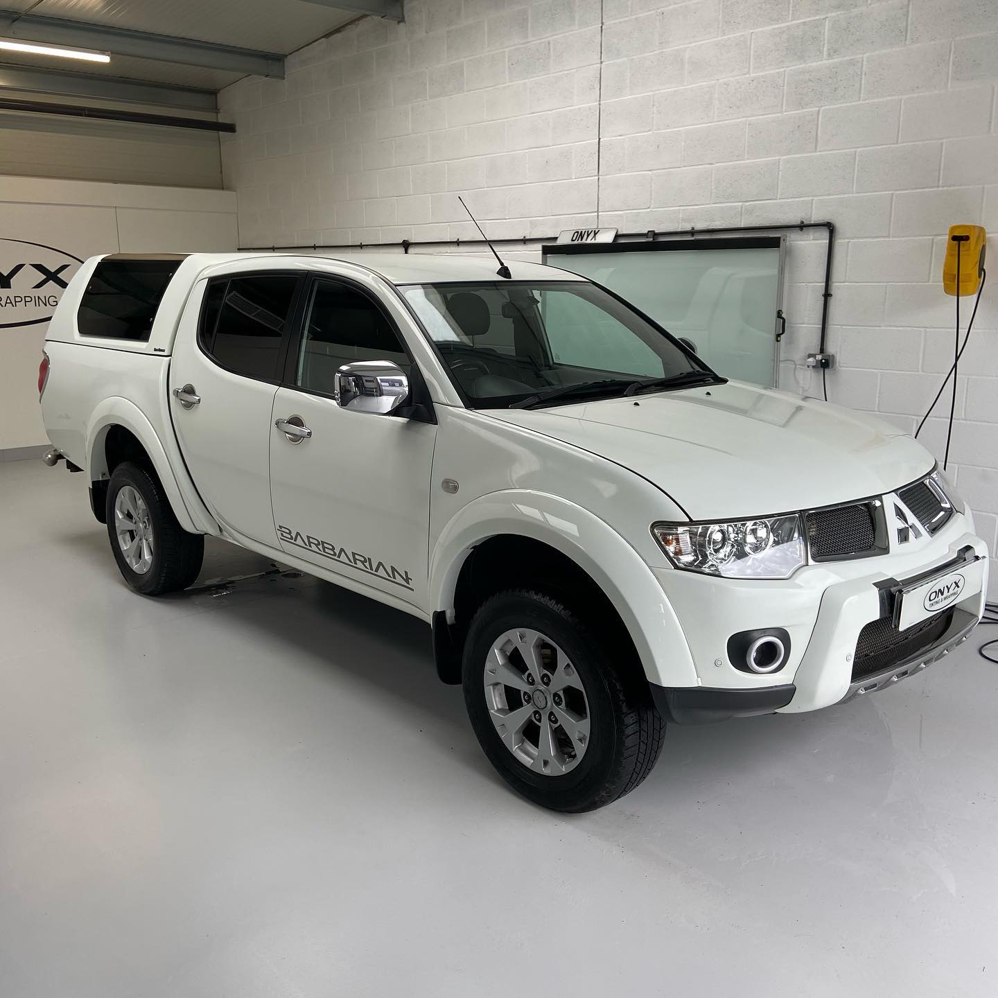 White Mitsubishi L200 Barbarian double-cab pickup after a full valet